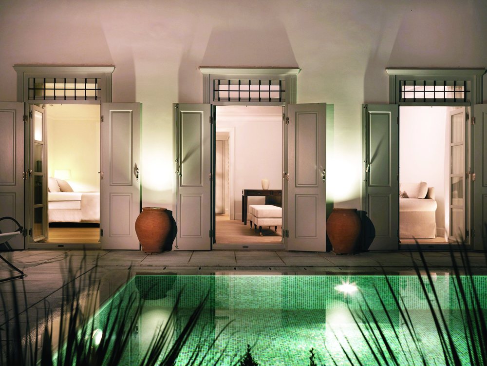 The Pool Suite at night, doors opening onto the private pool, Poseidonion