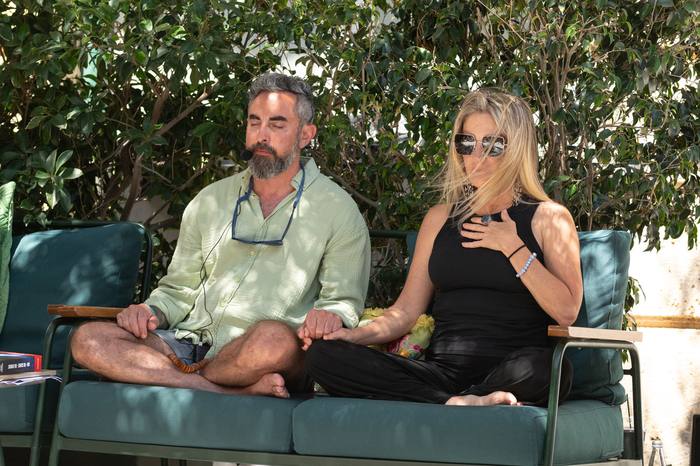 Couples work — hands joined in meditation
