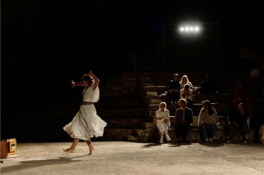 A dancer in white in the night amphitheatre